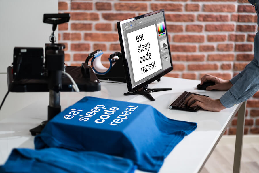 A designer is checking the print artworks on a computer